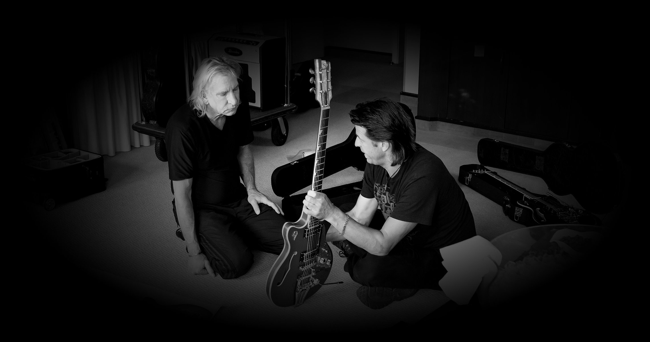 DAC-JW_Hero-Hotel.jpg Photo of Joe Walsh and Duesenberg CEO Ingo Renner in a Hotel room discussing guitars